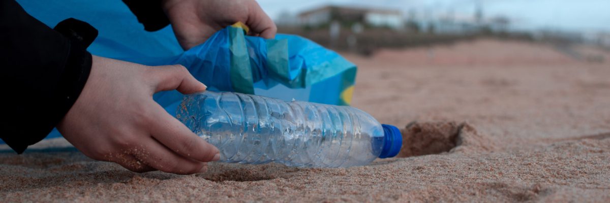 Person holding clear plastic bottle